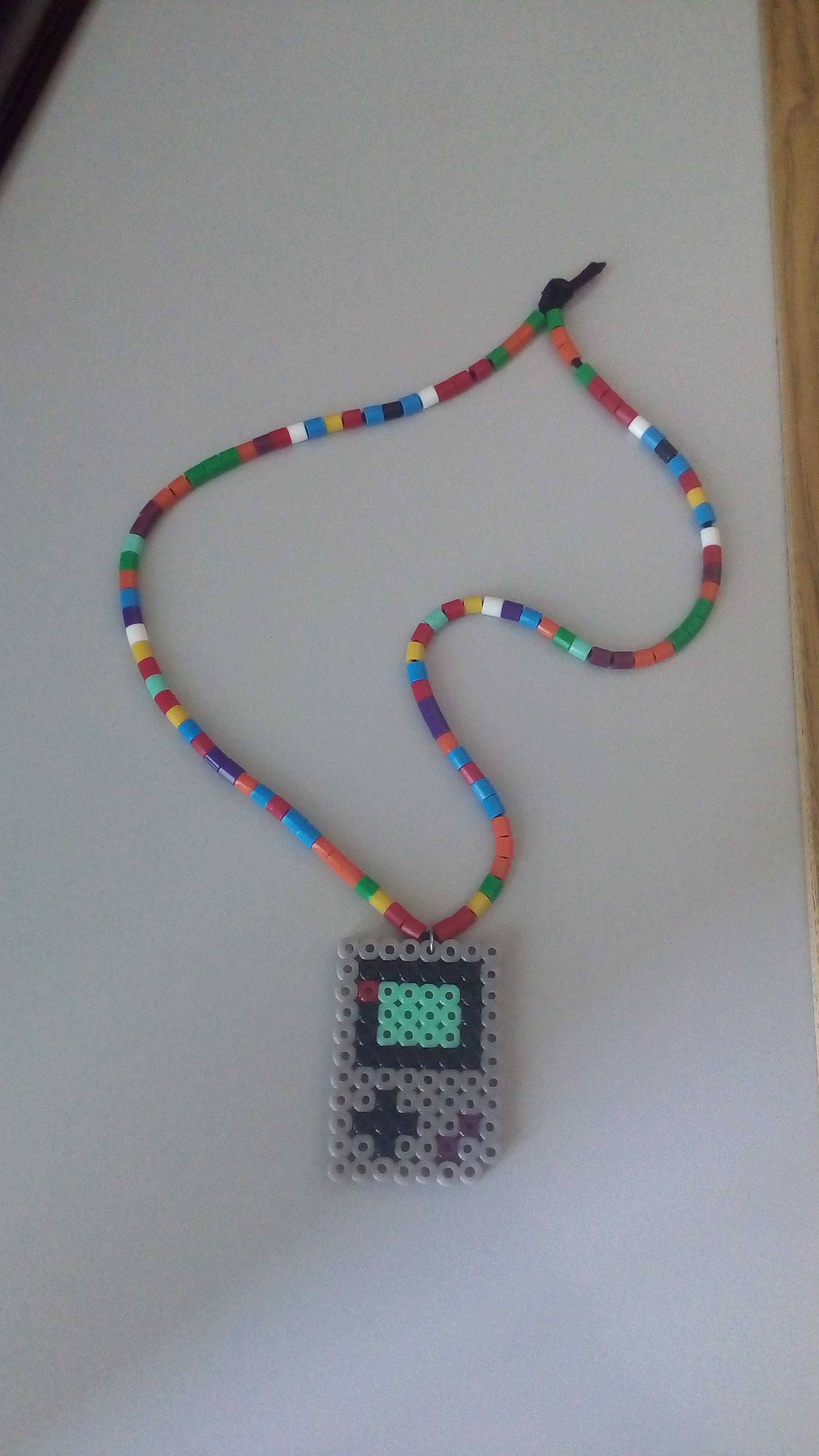 Colored perler beads necklace with Game Boy DMG 001
