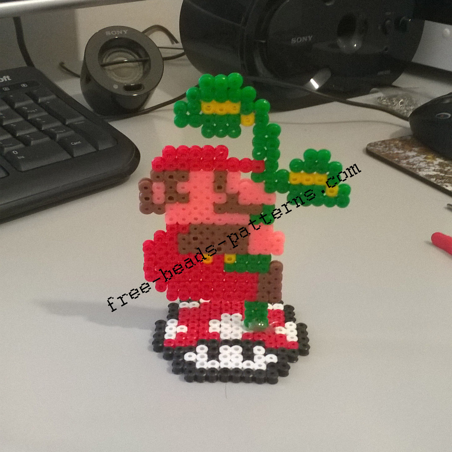 Super Mario Bros climbing the plant 2D perler beads on pedestal photos (3)